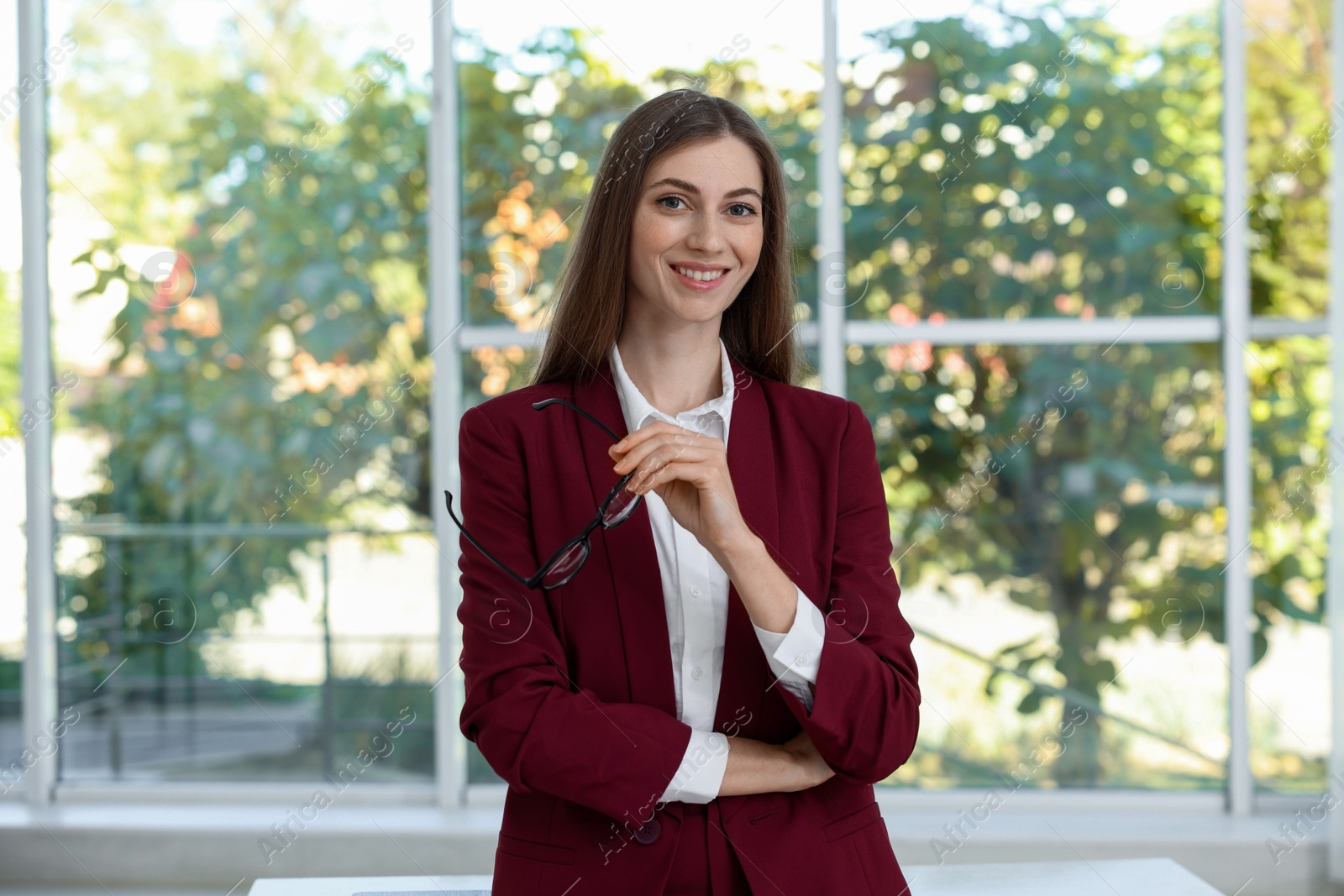 Photo of Portrait of young woman wearing stylish suit indoors