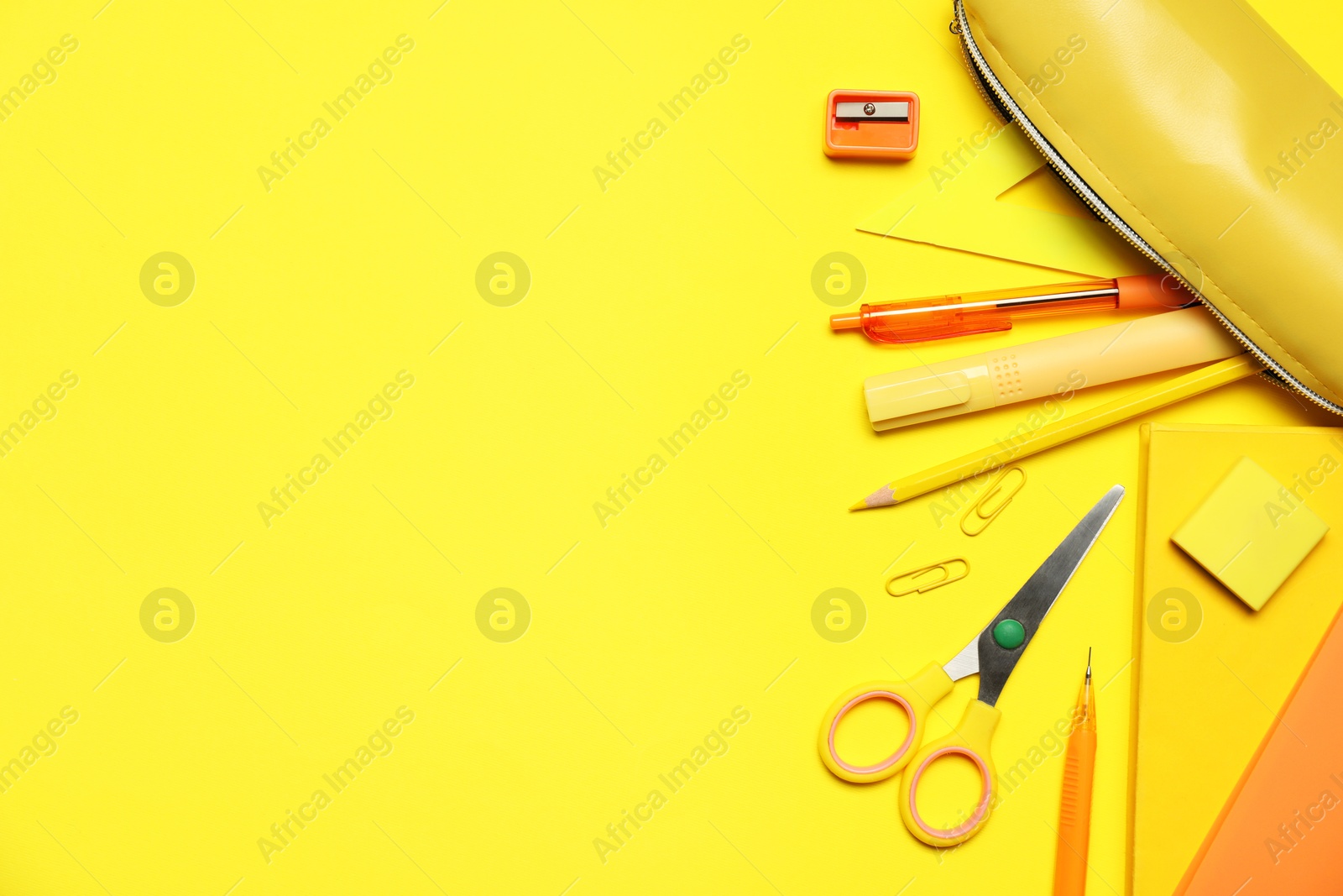 Different stationery on yellow background, flat lay. Space for text Photo of Different stationery on yellow background, flat lay. Space for text