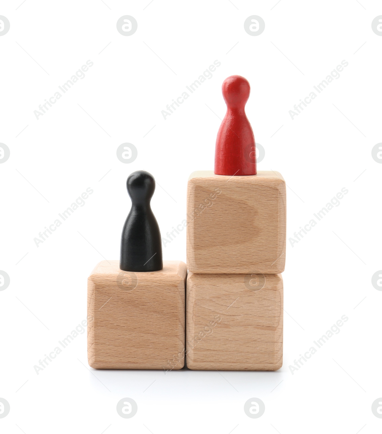 Photo of Human figures on wooden blocks, red one on top against white background. Competition concept