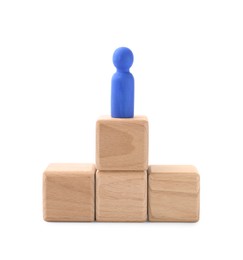 Photo of Blue human figure on wooden blocks against white background. Competition concept