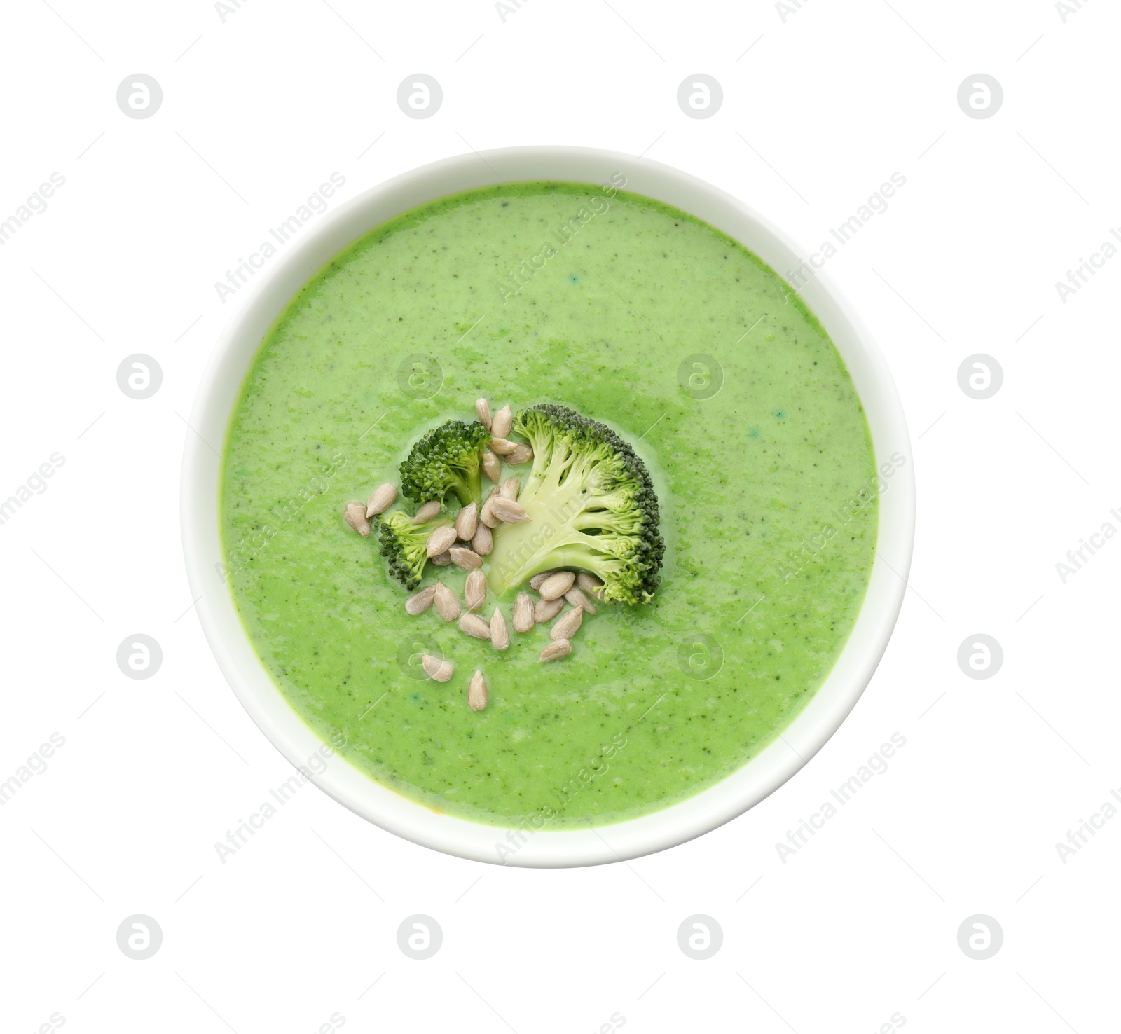 Photo of Delicious broccoli cream soup with sunflower seeds in bowl isolated on white, top view