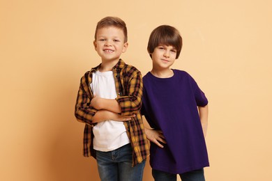 Photo of Portrait of cute brothers on beige background