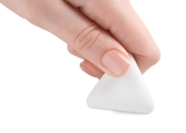 Photo of Woman using eraser on white background, closeup