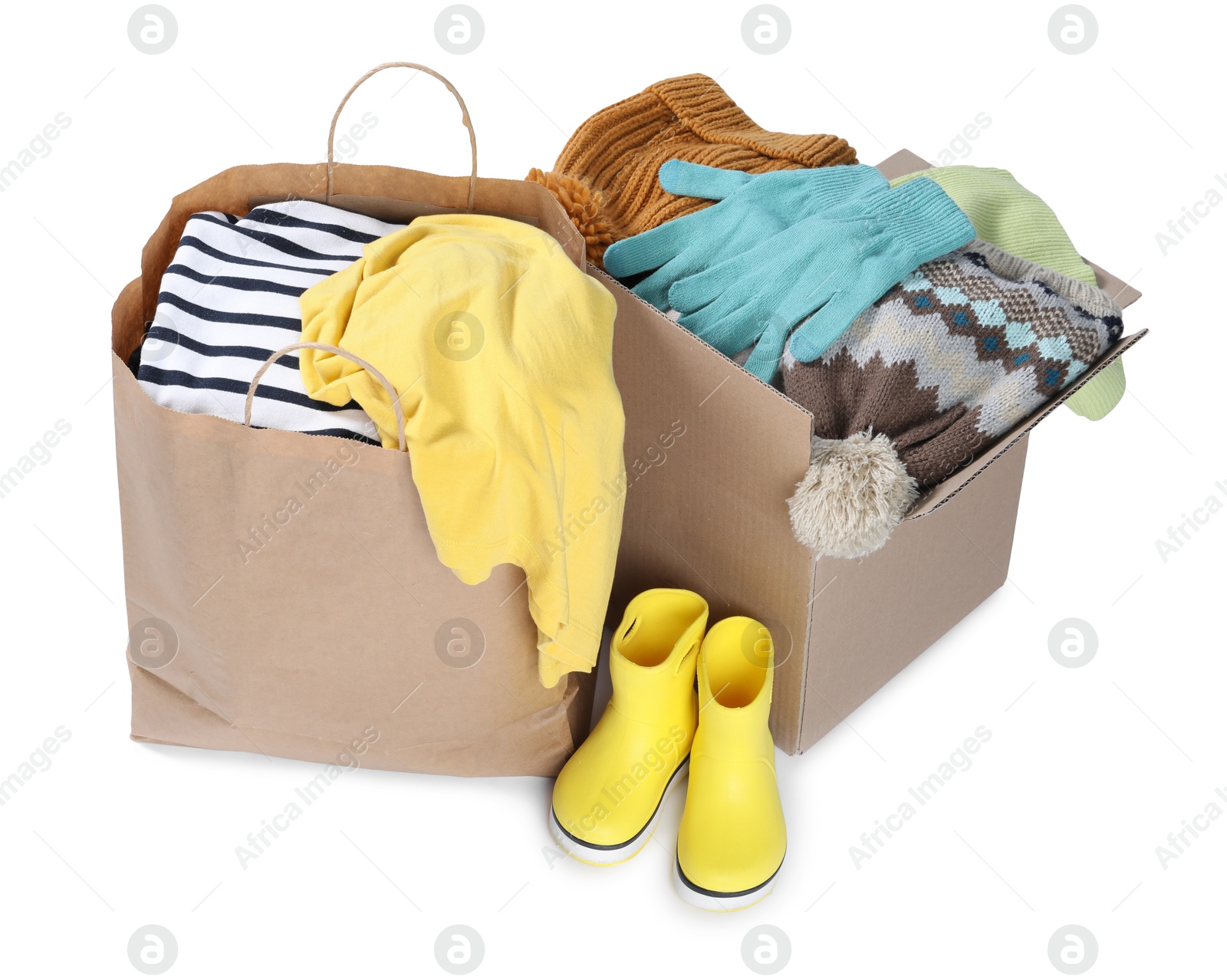 Photo of Packed used clothes and boots isolated on white