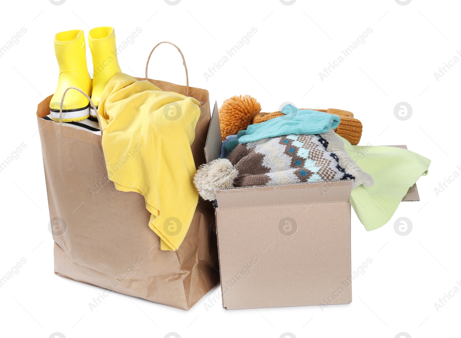 Photo of Packed used clothes and boots isolated on white