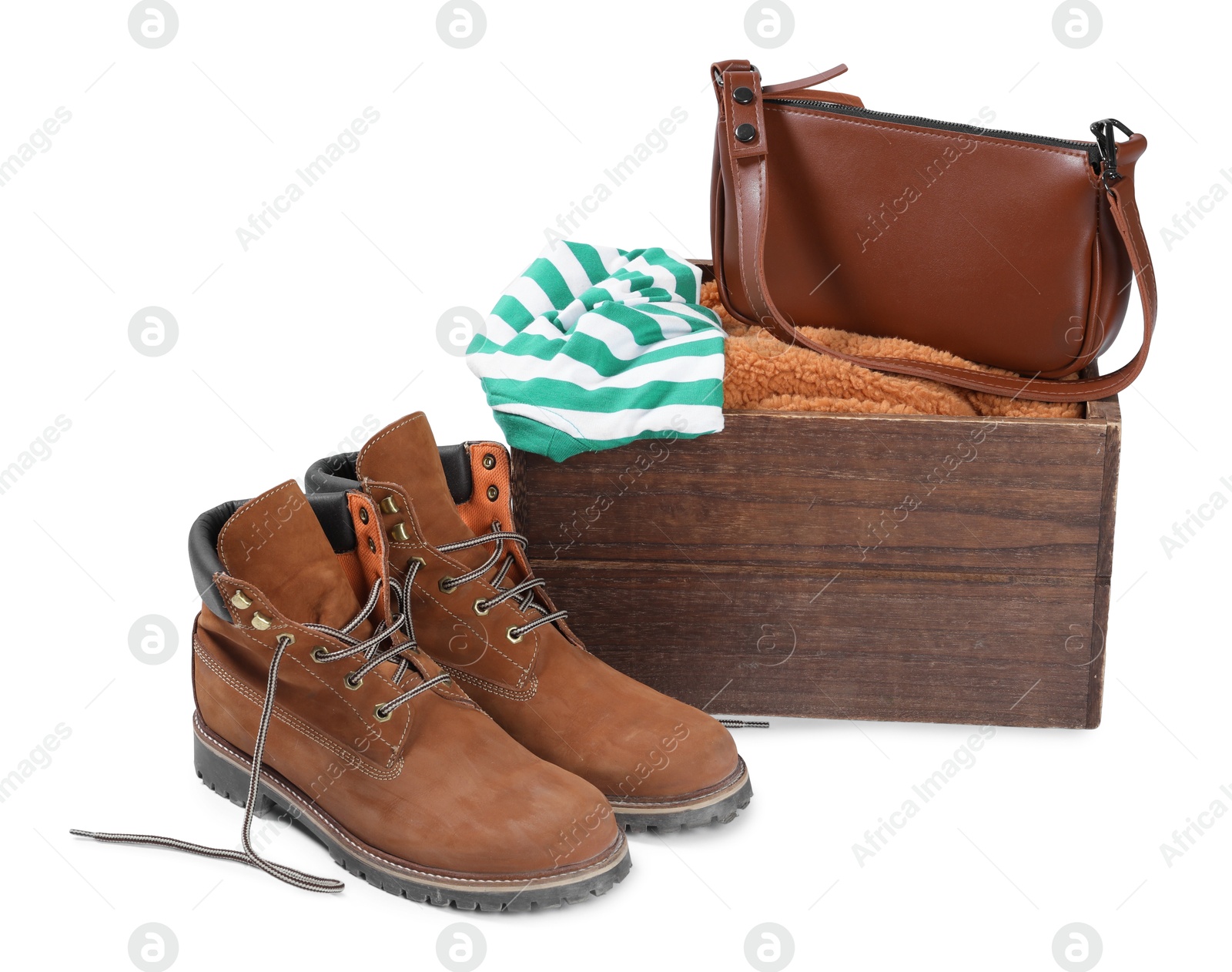 Photo of Crate with used clothes, bag and shoes isolated on white