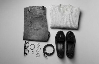 Photo of Stylish clothes and accessories on grey background, flat lay. Fashion concept