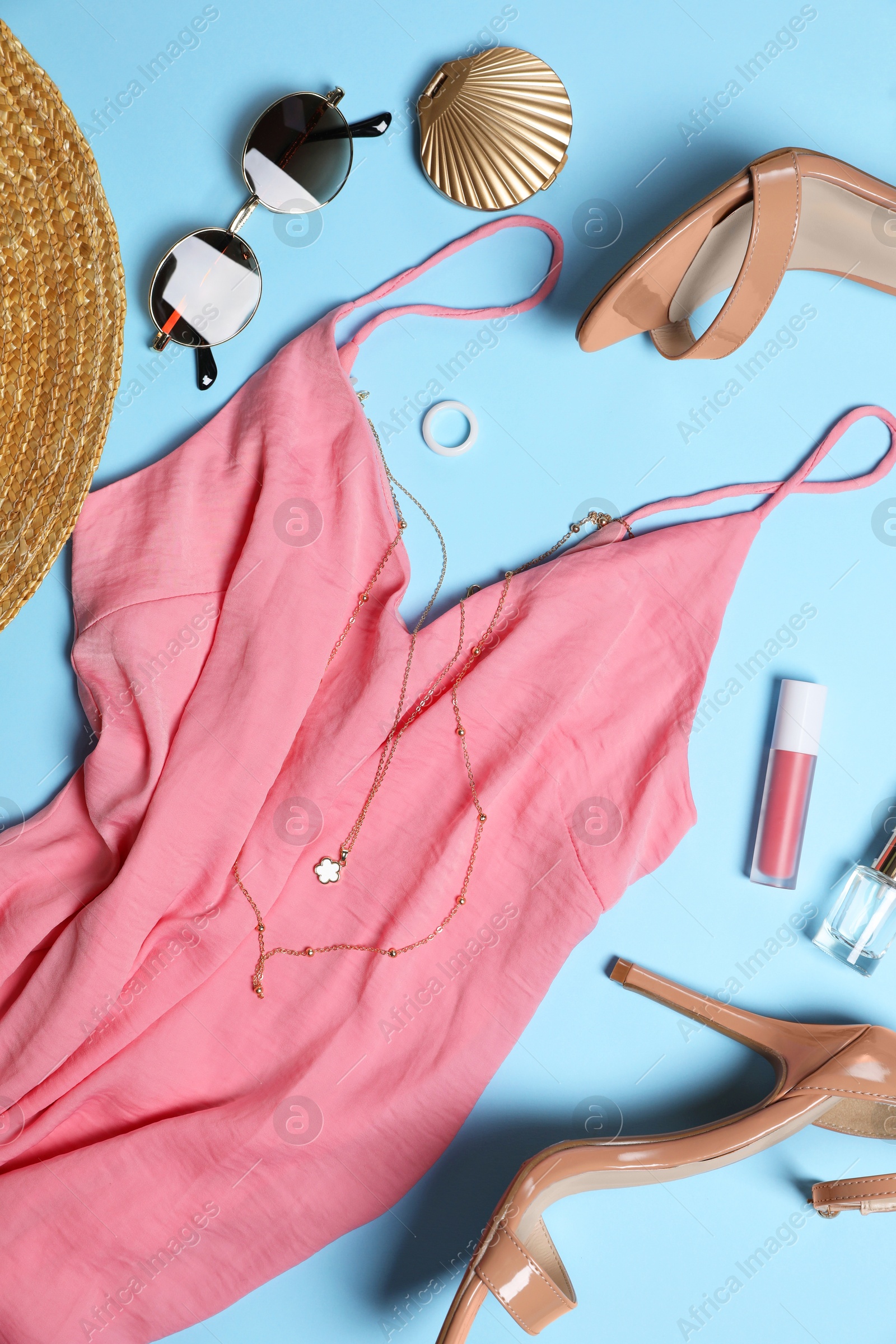 Photo of Stylish women's clothes and different accessories on light blue background, flat lay