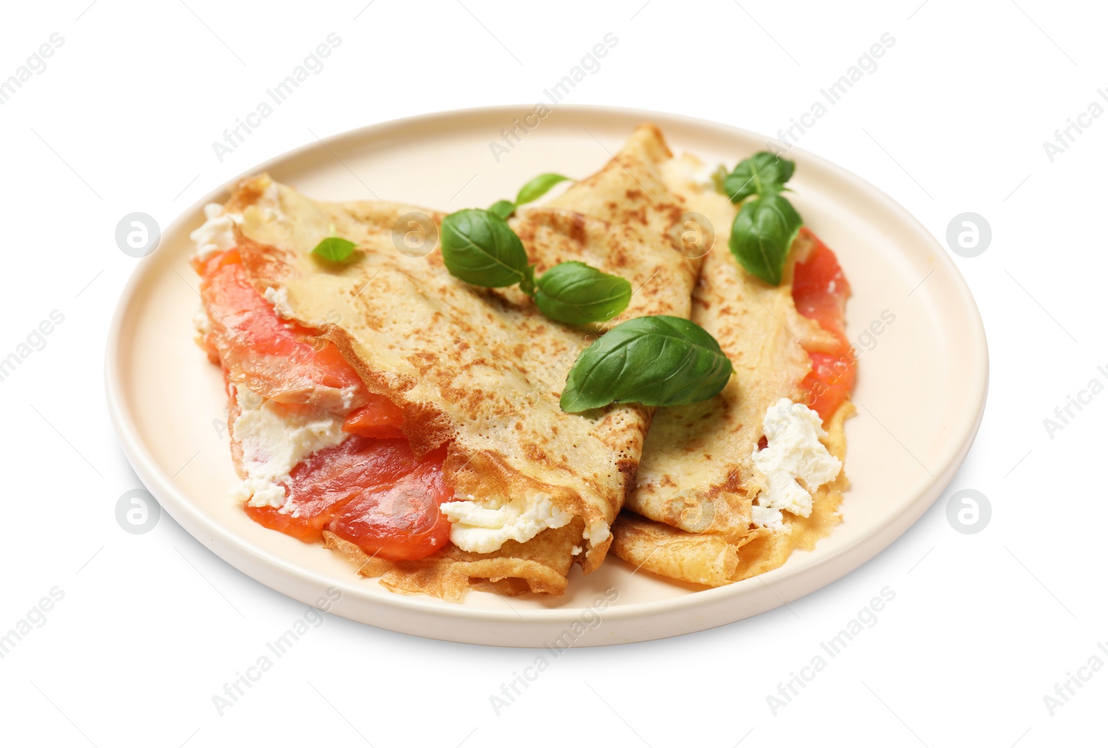 Photo of Delicious crepes with salmon, cream cheese and basil isolated on white