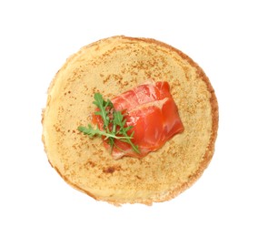 Photo of Delicious crepe with salmon and arugula isolated on white, top view