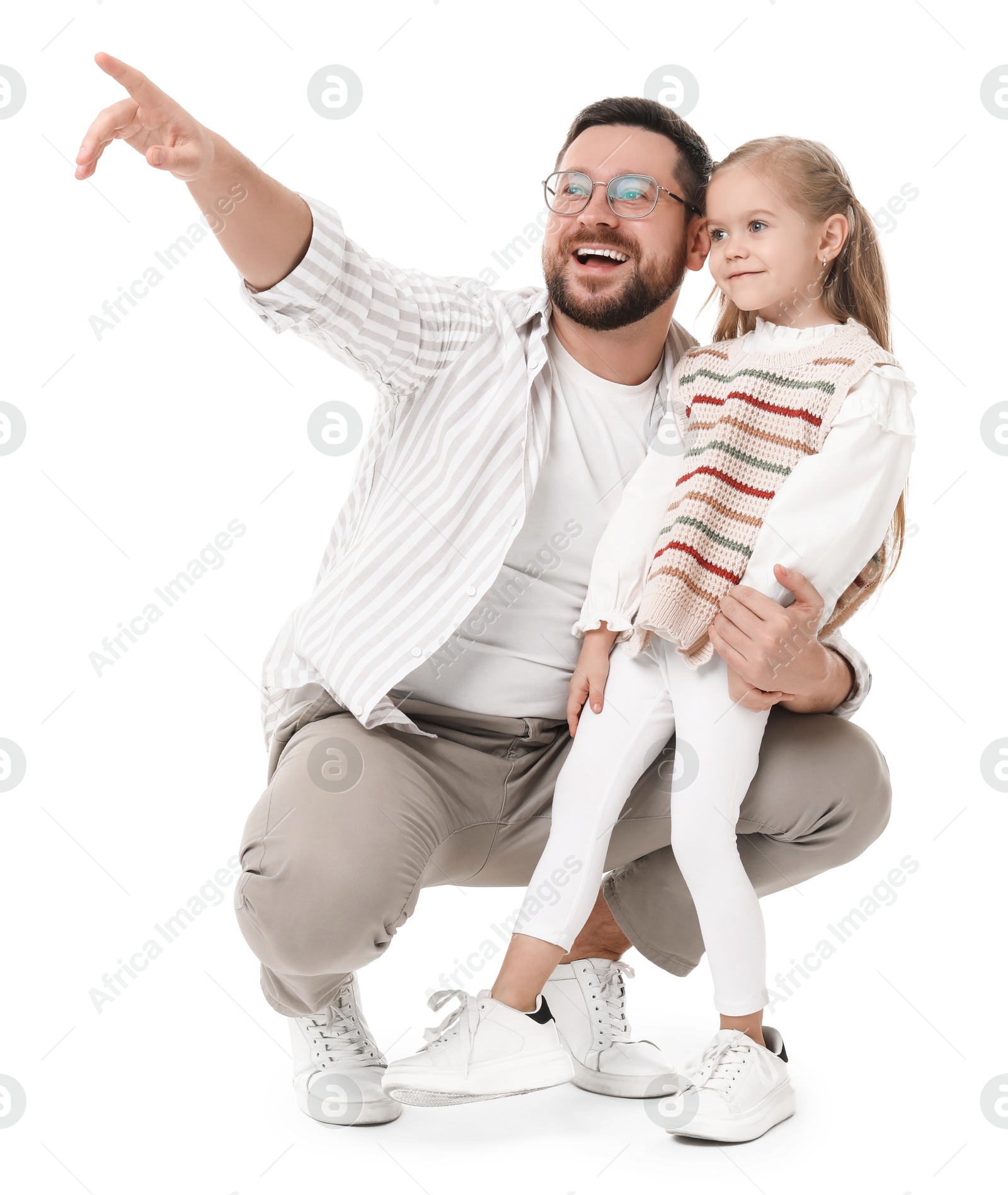 Photo of Happy father with his cute little daughter looking at something on white background