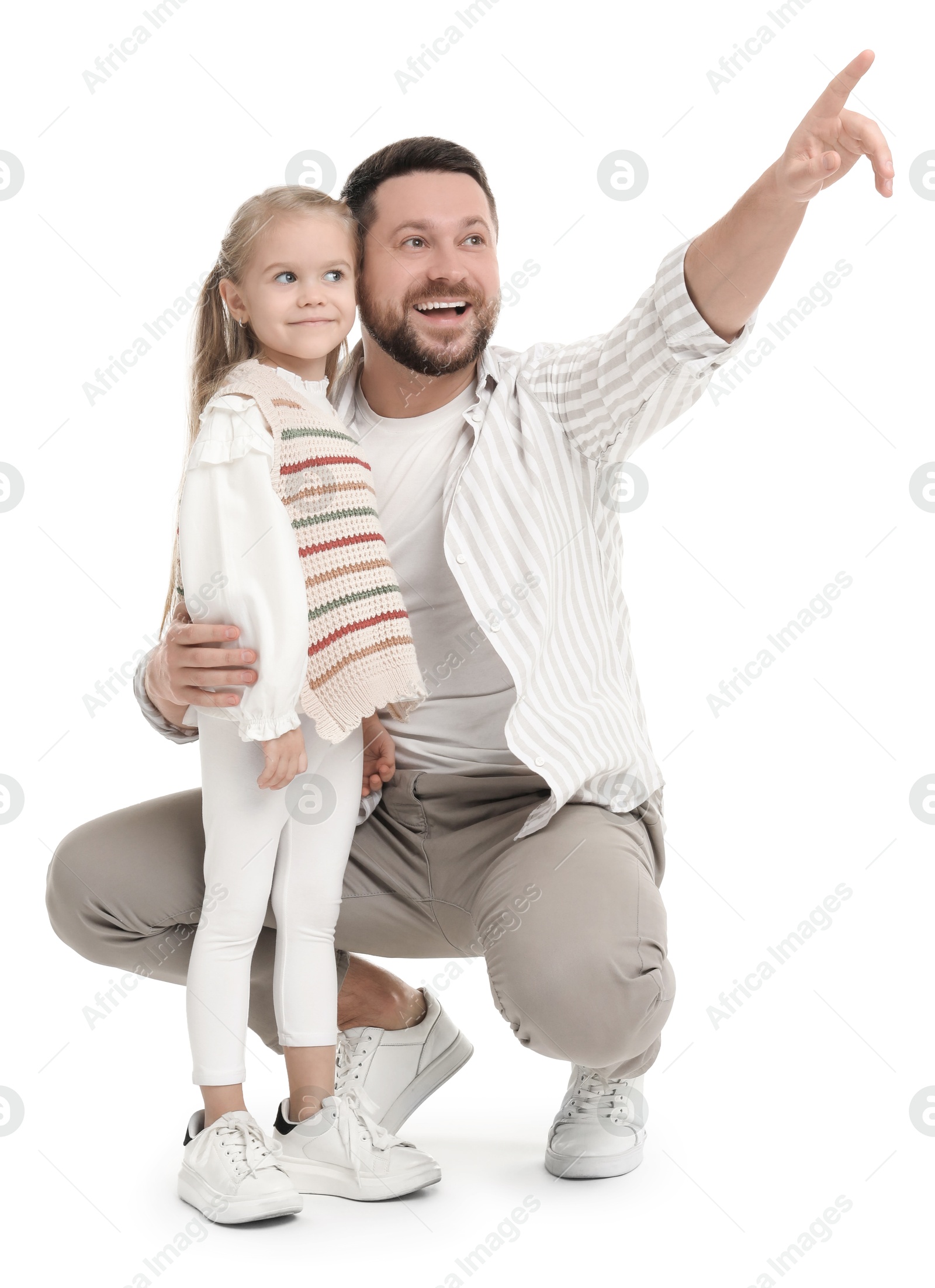 Photo of Happy father with his cute little daughter looking at something on white background