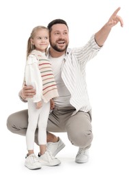 Photo of Happy father with his cute little daughter looking at something on white background