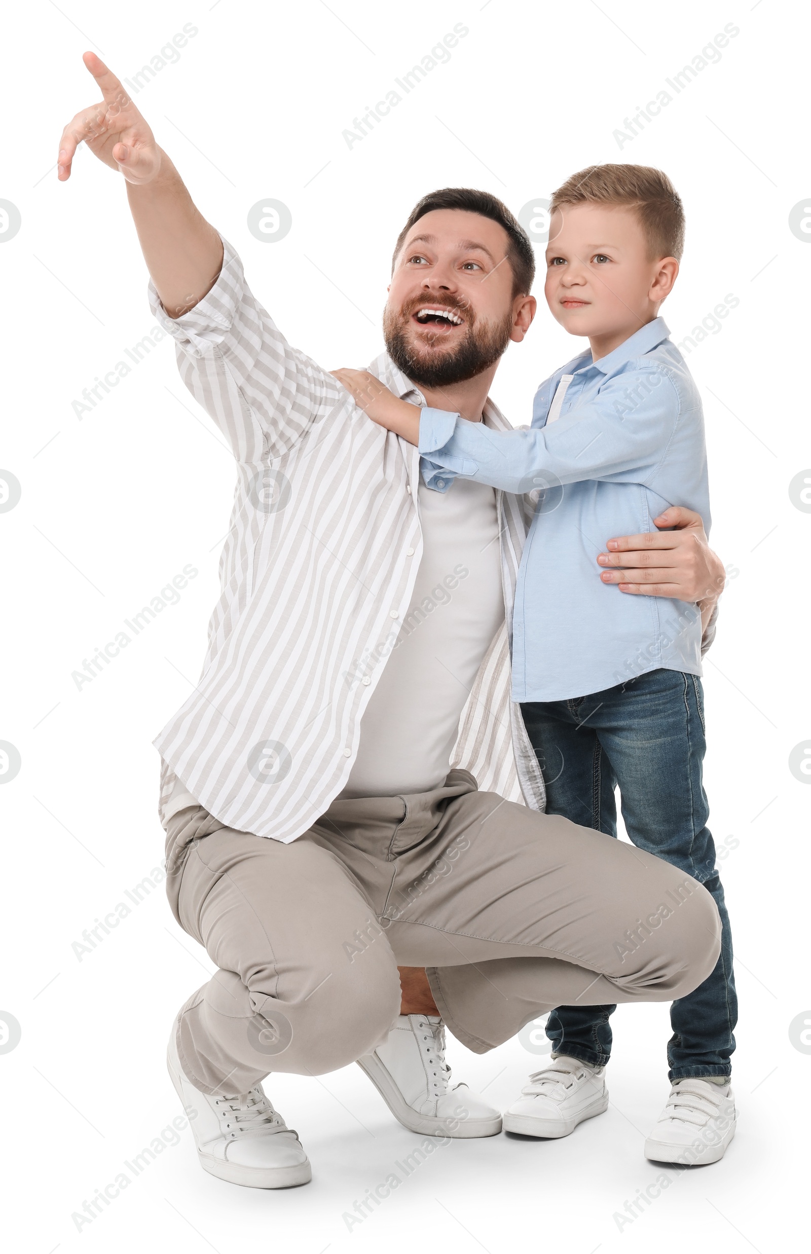 Photo of Happy father with his cute little son looking at something on white background