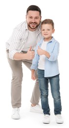 Photo of Happy father with his cute little son showing thumbs up on white background