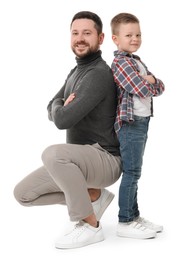 Photo of Happy father with his cute little son on white background