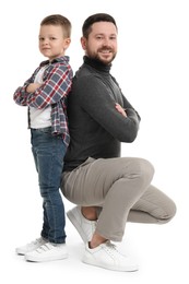 Happy father with his cute little son on white background