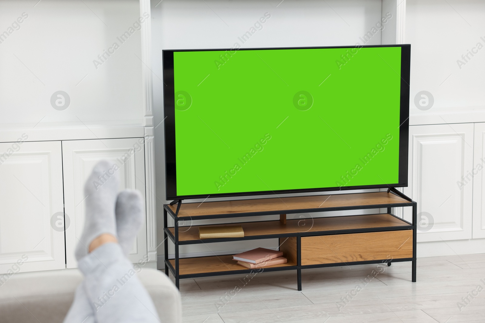 Photo of Man watching TV on sofa at home, closeup