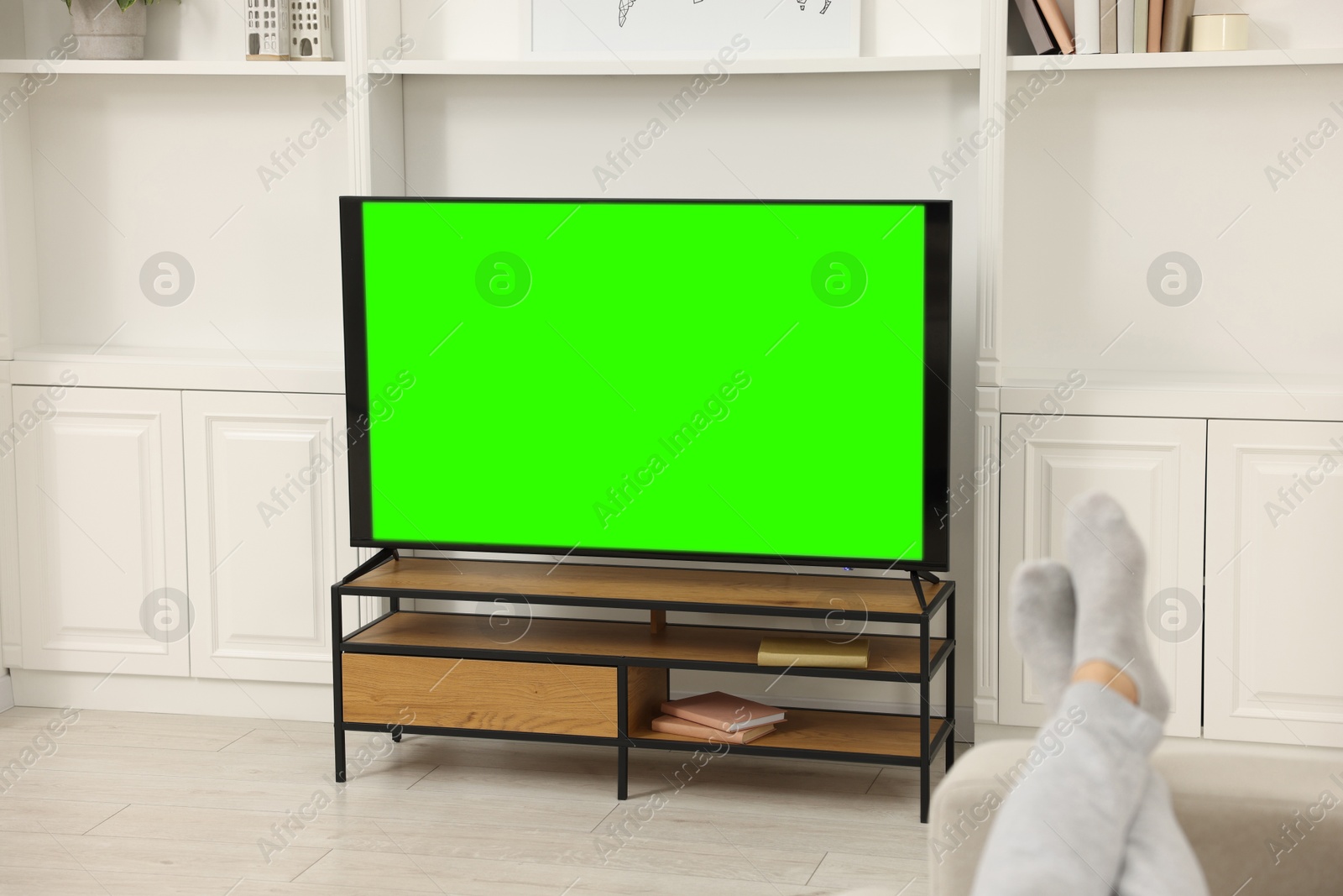 Photo of Man watching TV on sofa at home, closeup