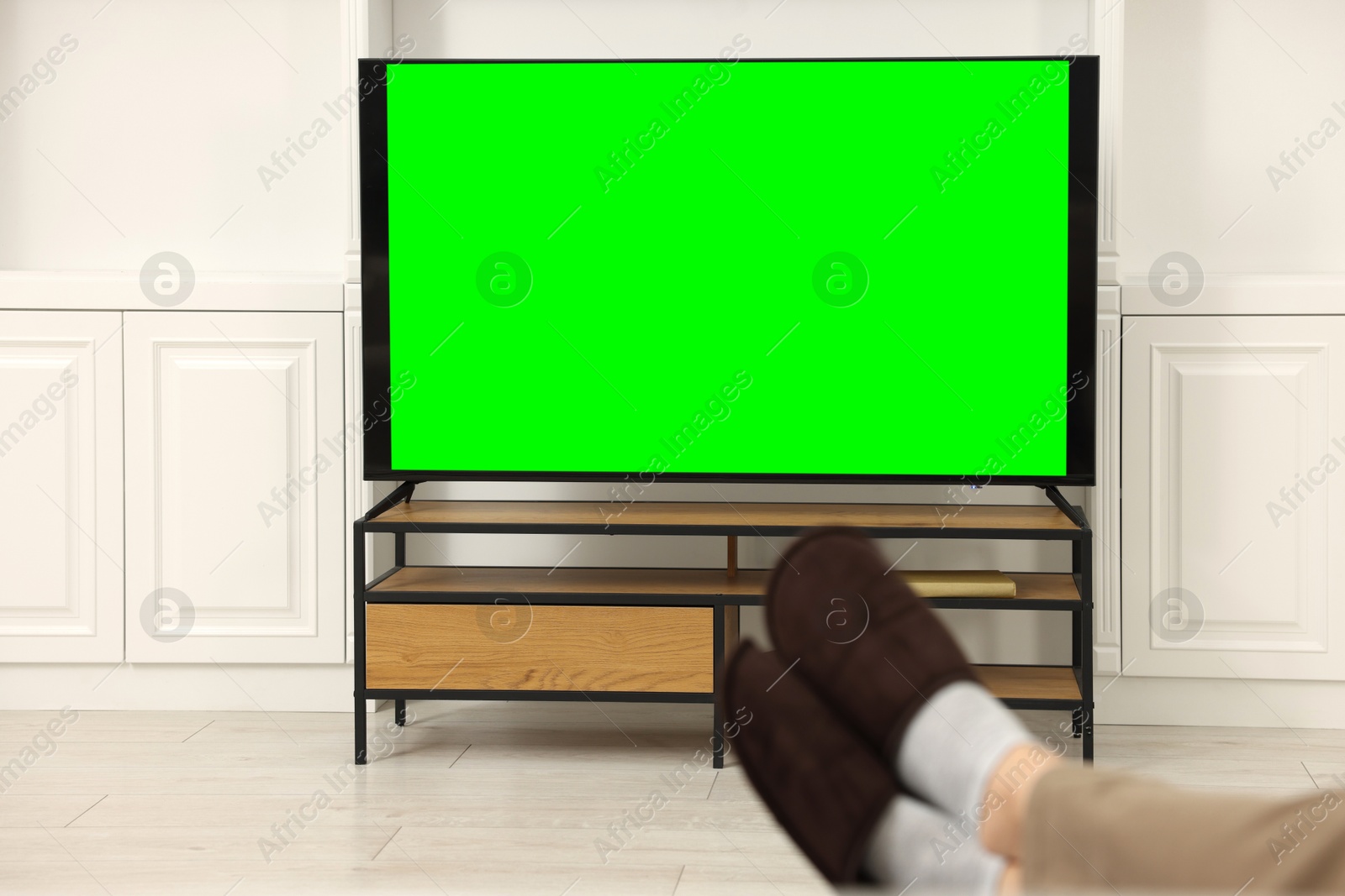 Photo of Man watching TV in living room, closeup