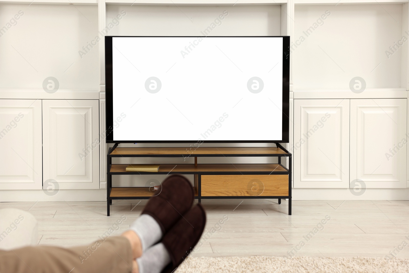 Photo of Man watching TV in living room, closeup