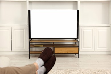 Photo of Man watching TV in living room, closeup