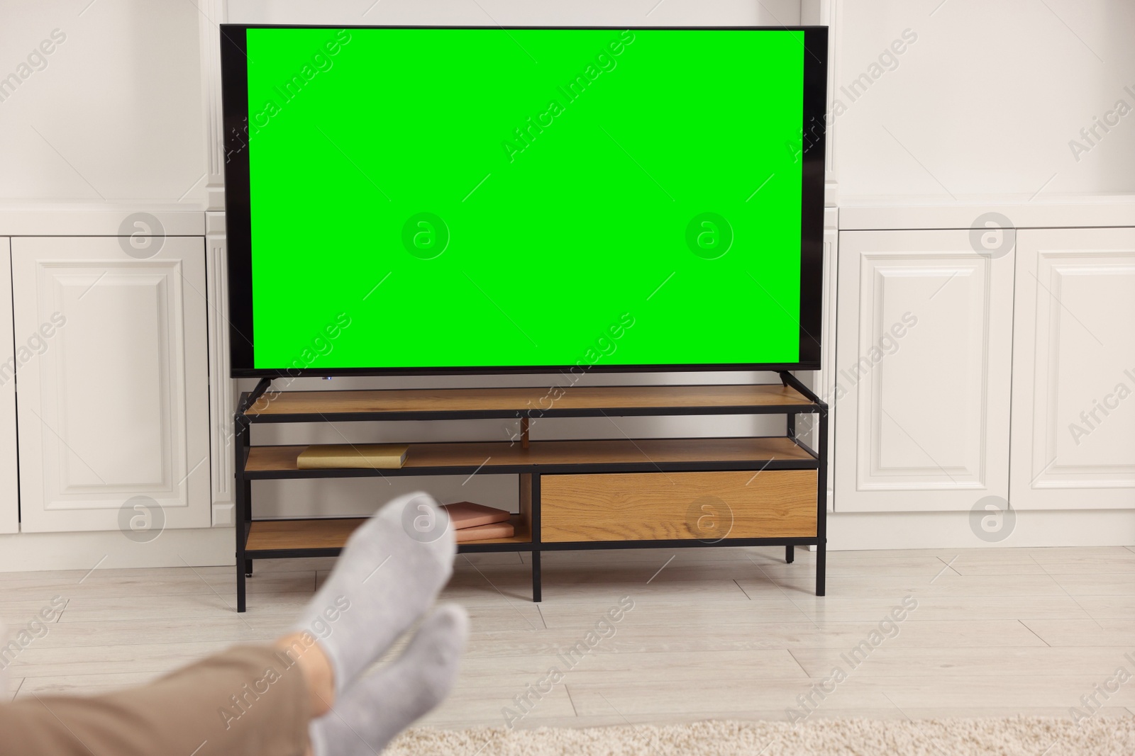 Photo of Man watching TV in living room, closeup