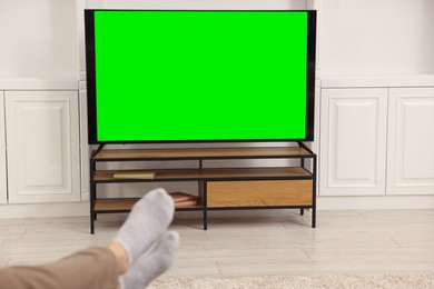 Photo of Man watching TV in living room, closeup