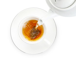 Photo of Pouring hot water into cup with tea bag on white background, top view