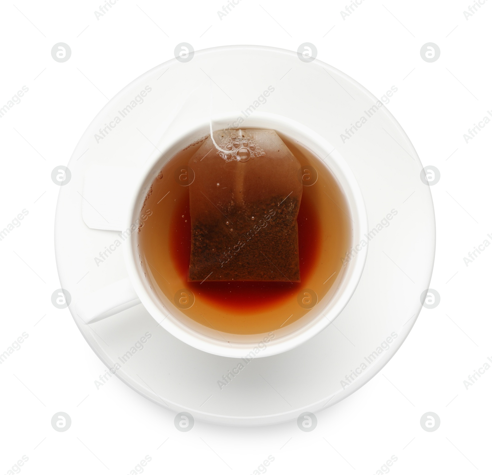 Photo of Tea bag in cup with hot drink isolated on white, top view