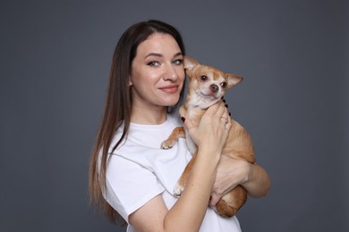 Photo of Beautiful woman with her cute Chihuahua dog on grey background