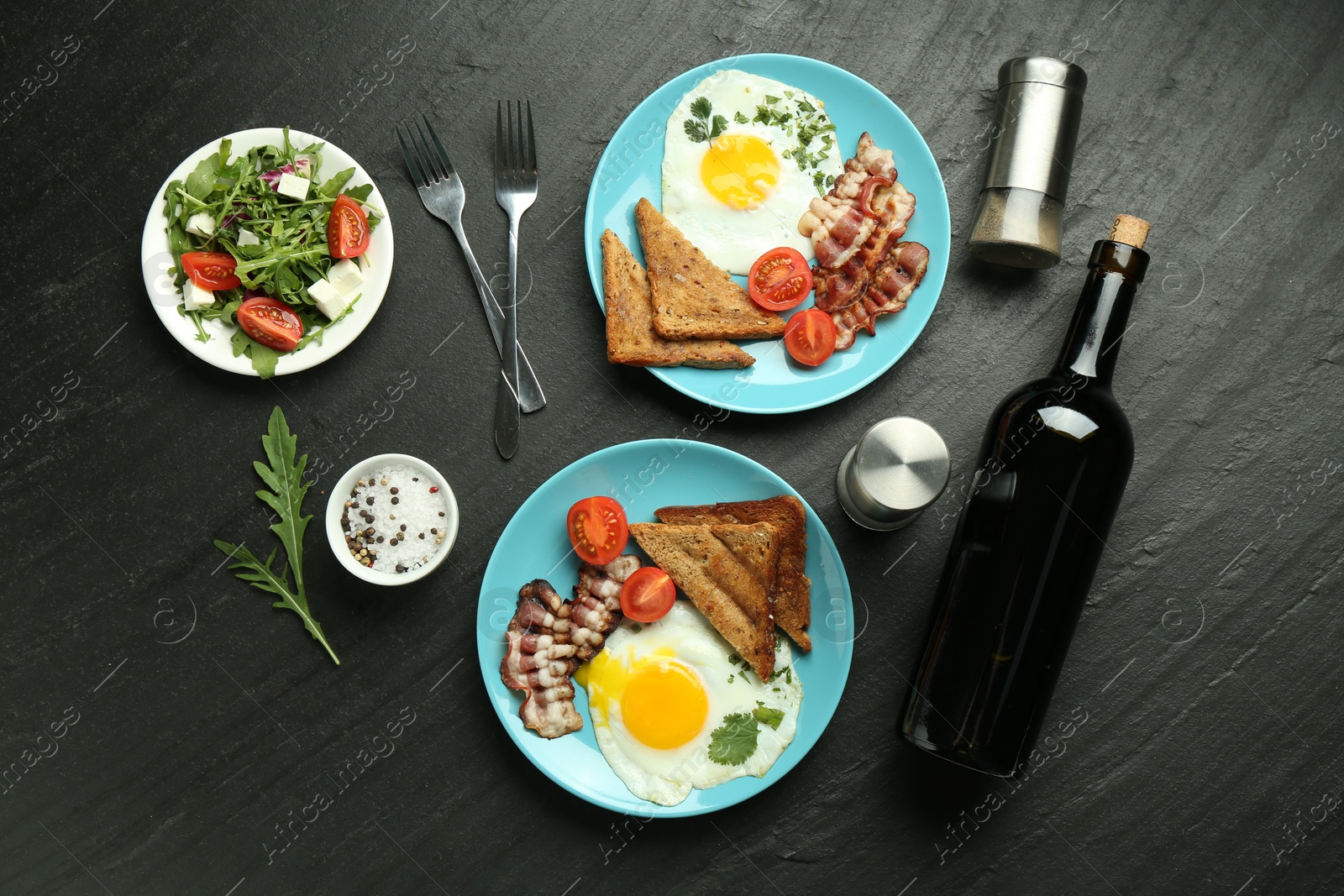 Photo of Tasty food served for brunch on black table, flat lay