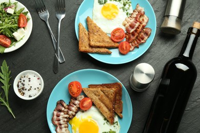 Photo of Tasty food served for brunch on black table, flat lay