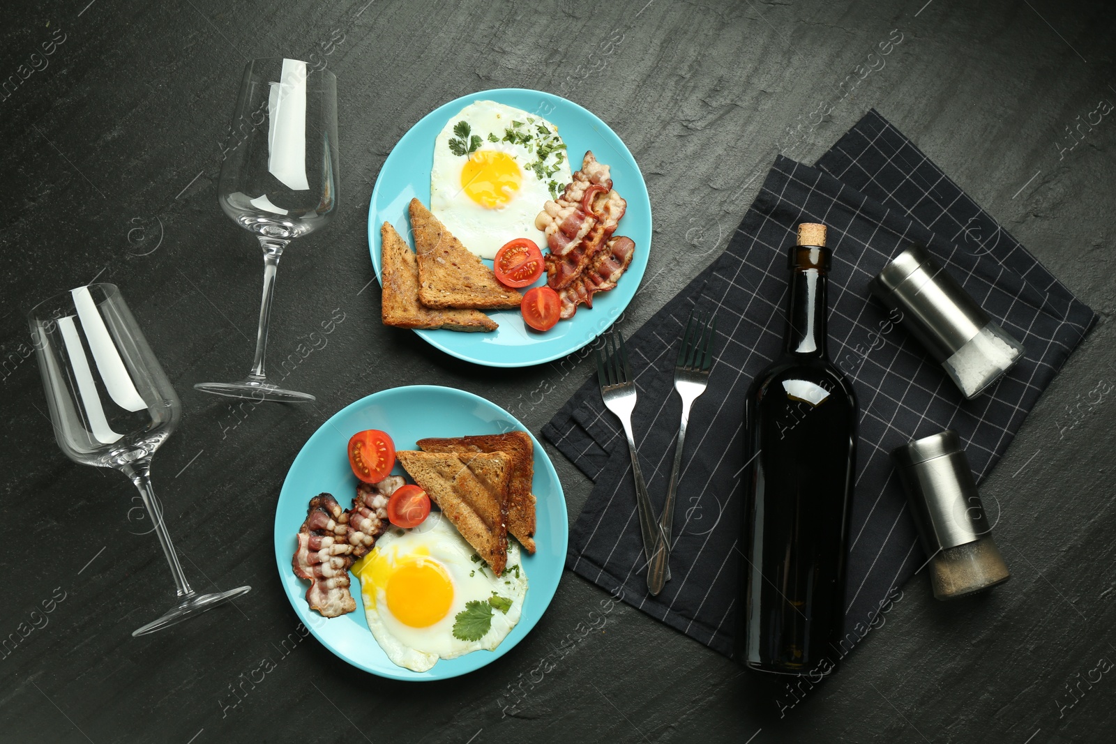 Photo of Tasty food served for brunch on black table, flat lay