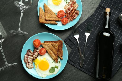 Photo of Tasty food served for brunch on black table, flat lay