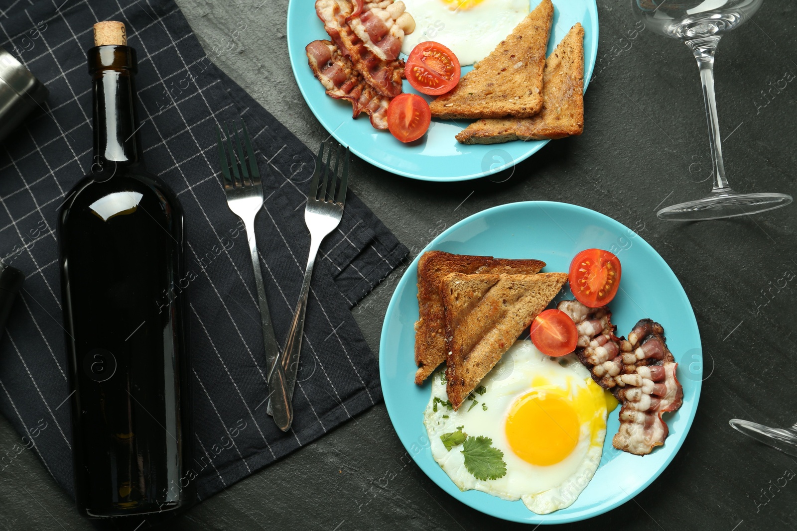 Photo of Tasty food served for brunch on black table, flat lay