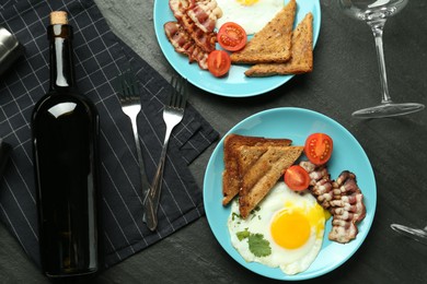 Photo of Tasty food served for brunch on black table, flat lay