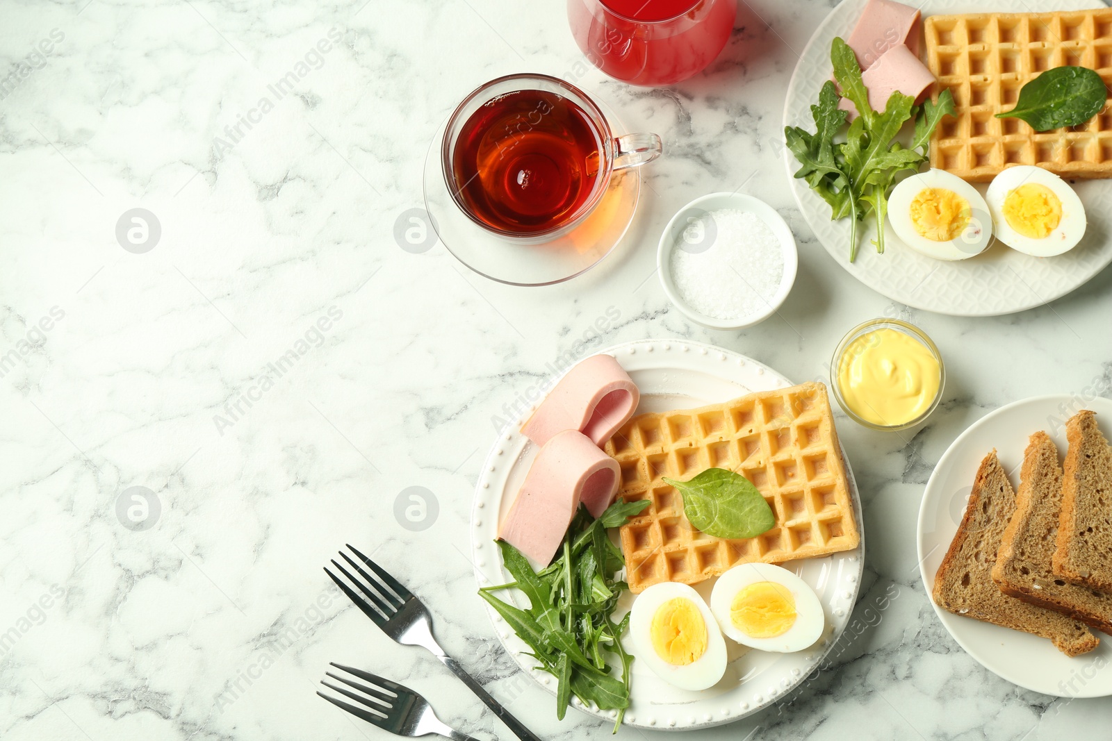 Photo of Flat lay composition with tasty brunch served on white marble table. Space for text