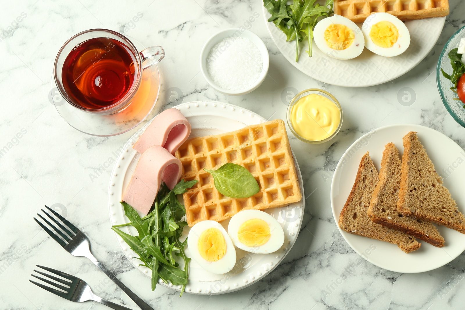 Photo of Flat lay composition with tasty brunch served on white marble table