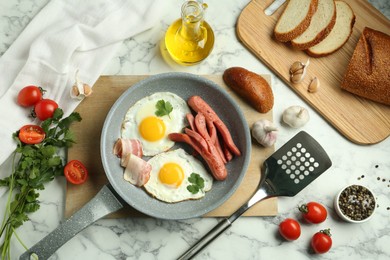 Photo of Tasty brunch. Fried eggs, sausages, bacon and other products on white marble table, flat lay