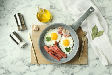 Photo of Tasty brunch. Fried eggs, sausages and bacon served on white marble table, flat lay