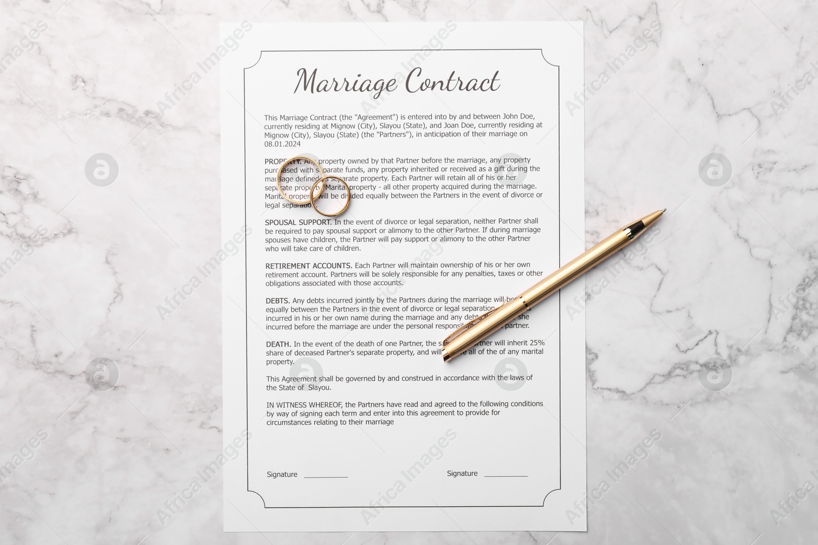 Photo of Marriage contract, pen and golden rings on white marble table, top view