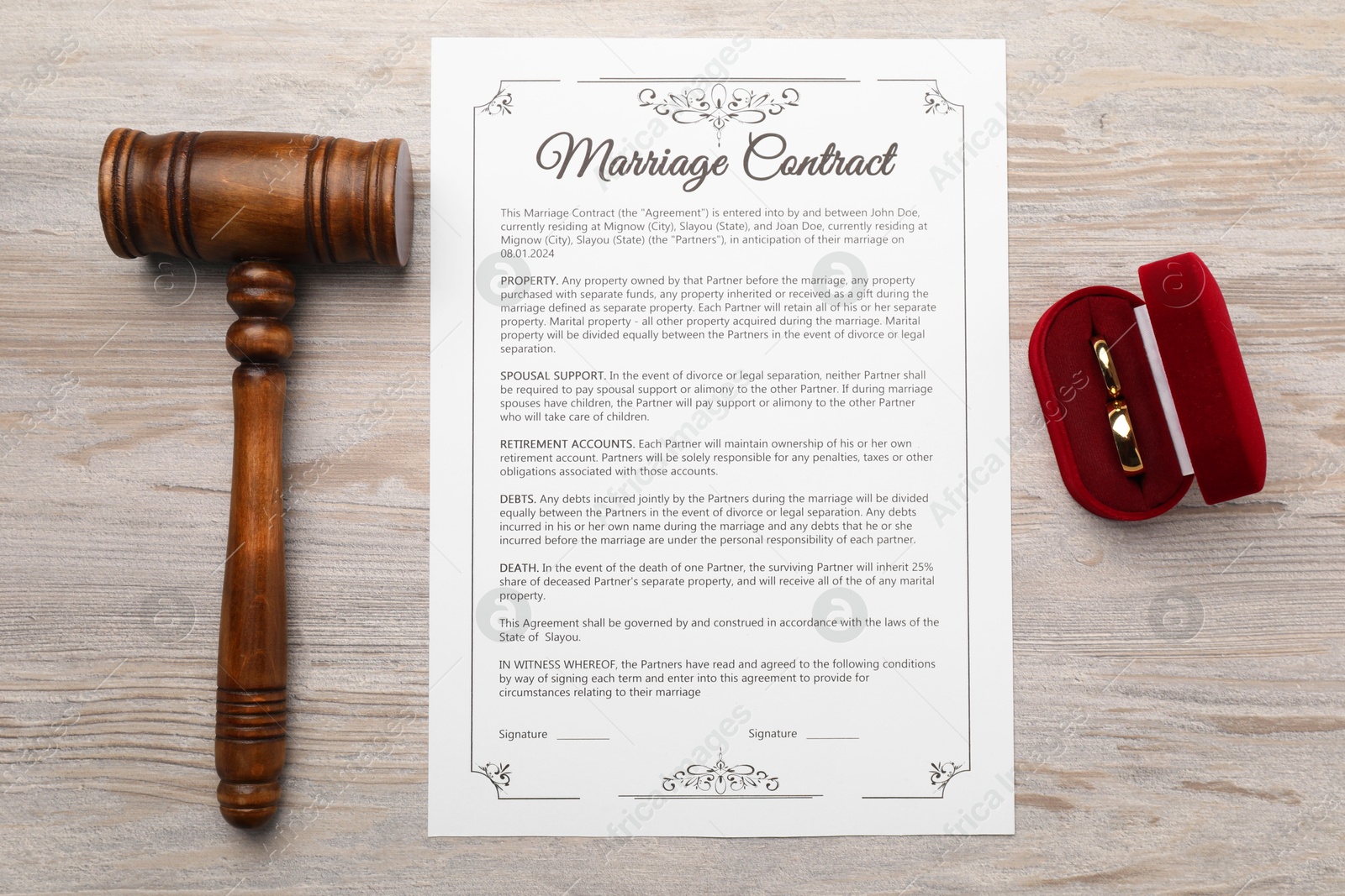 Photo of Marriage contract, gavel and golden rings on light wooden table, top view