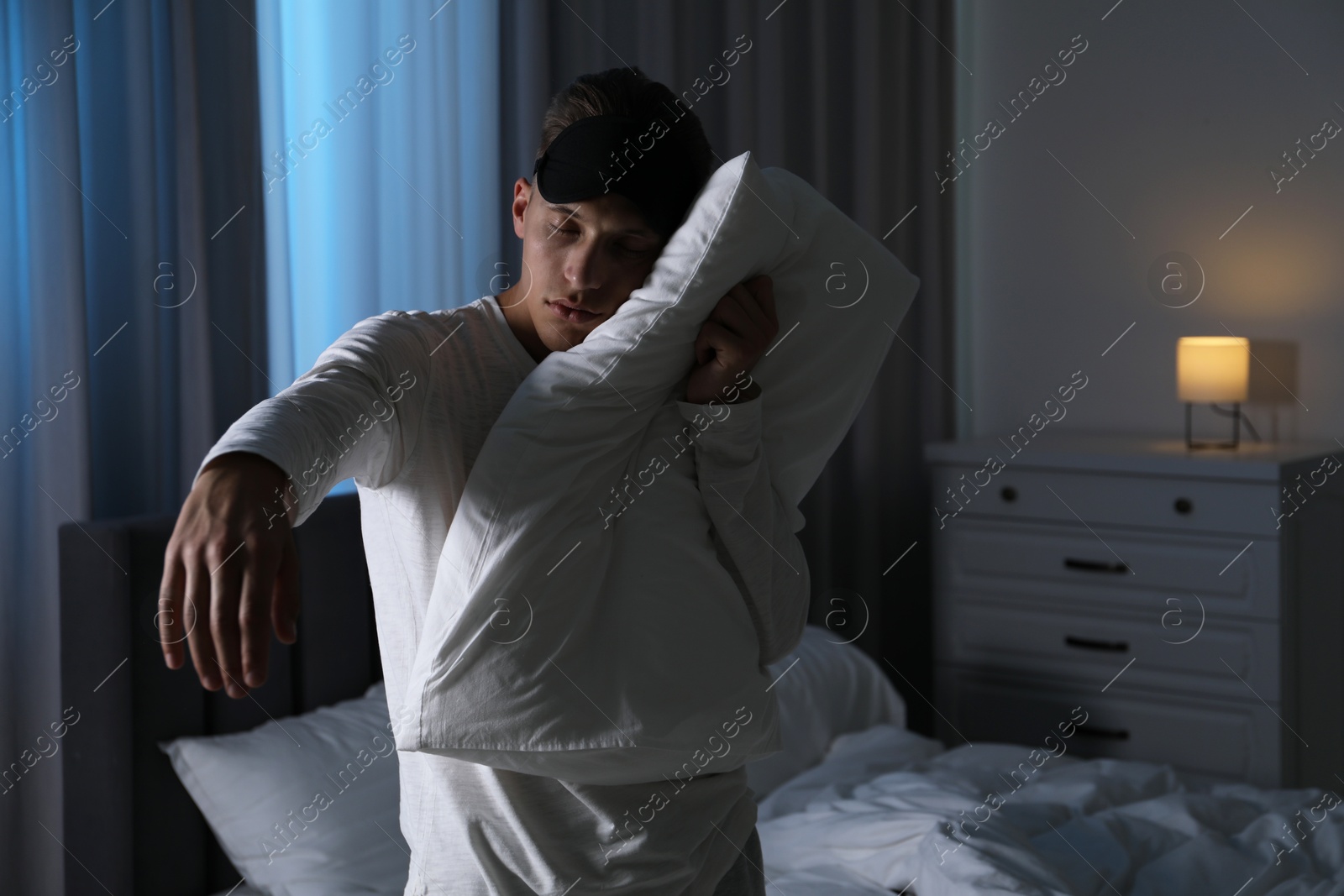 Photo of Young man suffering from sleepwalking at home