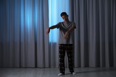 Photo of Young man suffering from sleepwalking at home