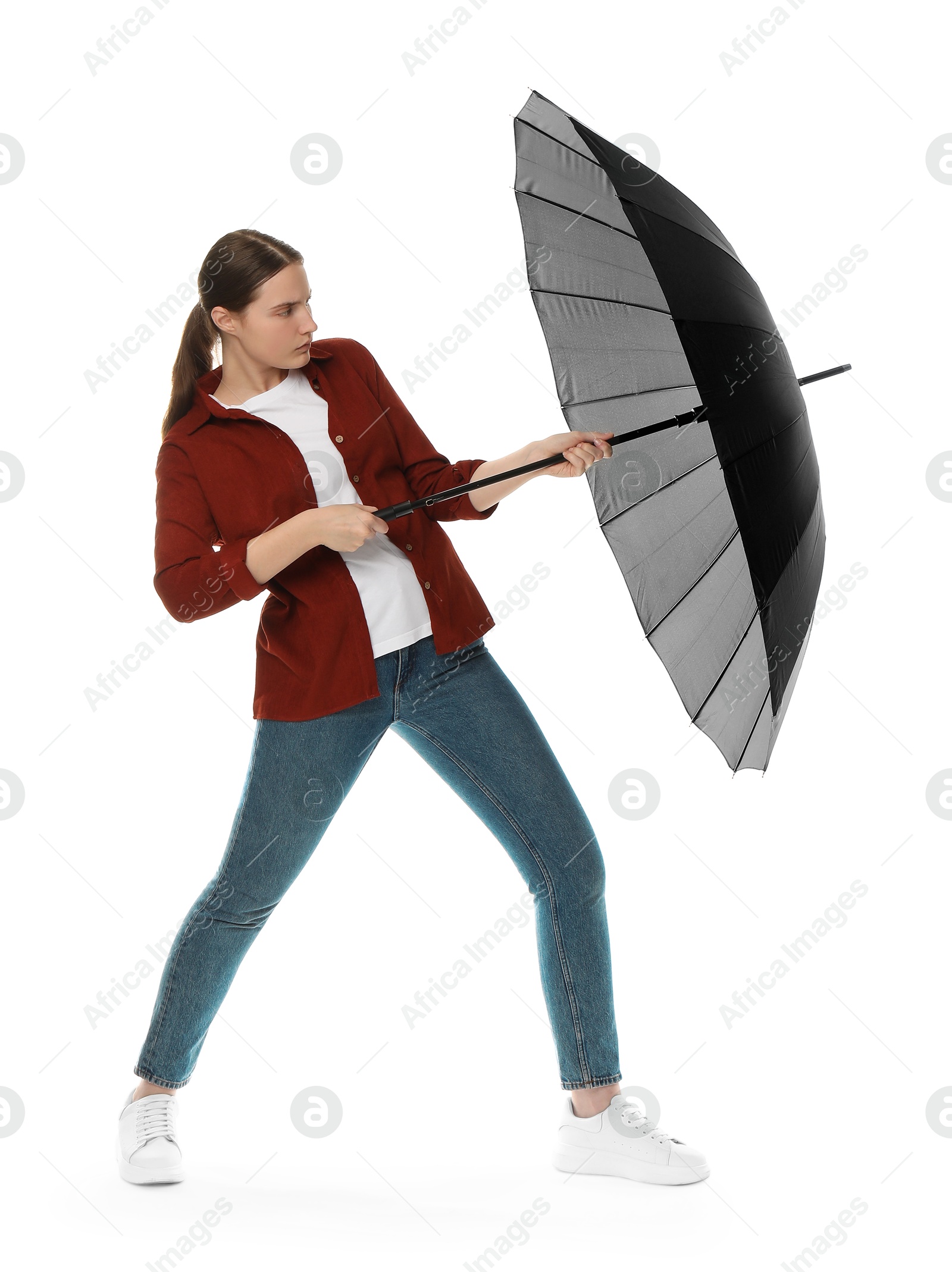 Photo of Young woman with black umbrella on white background