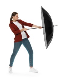 Photo of Young woman with black umbrella on white background