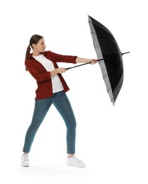 Photo of Young woman with black umbrella on white background