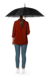 Photo of Young woman with black umbrella on white background, back view