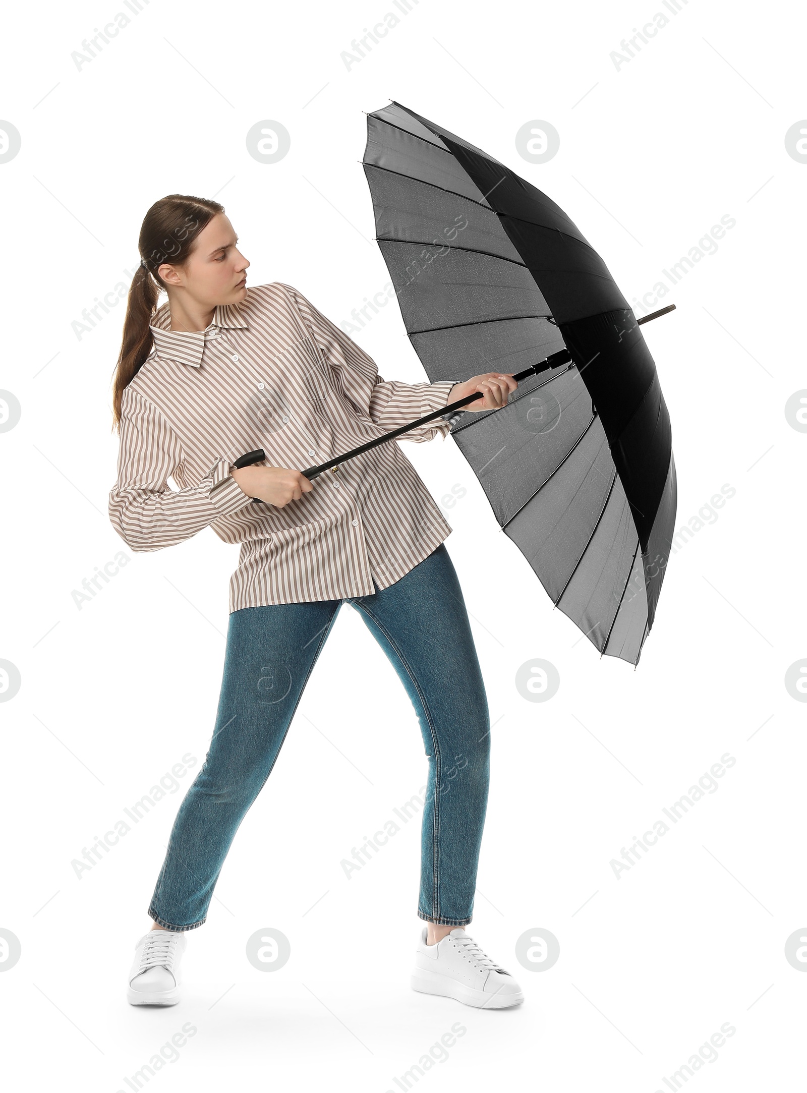 Photo of Young woman with black umbrella on white background